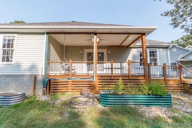 rear view of property with ceiling fan