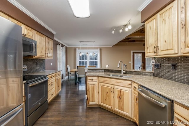 kitchen featuring kitchen peninsula, stainless steel appliances, sink, light brown cabinets, and hanging light fixtures