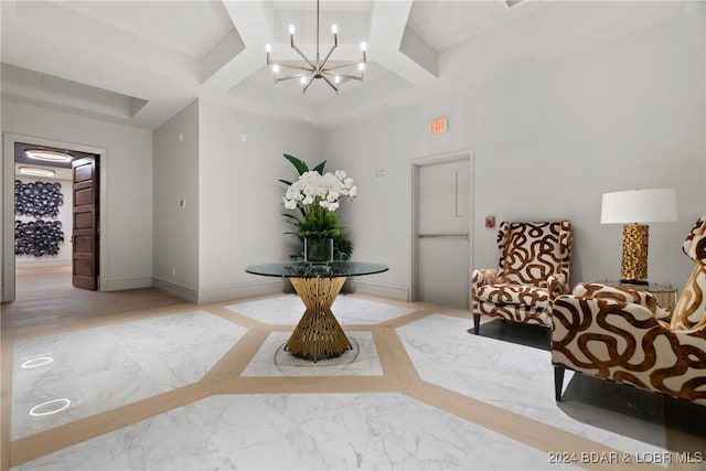 sitting room featuring beamed ceiling, a chandelier, and coffered ceiling