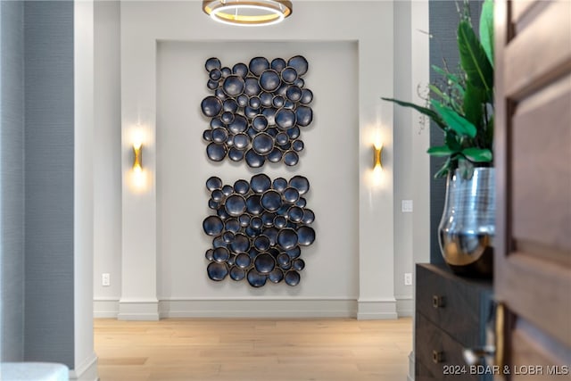 hallway with light hardwood / wood-style floors