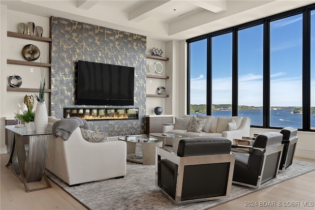 living room with beam ceiling and light wood-type flooring