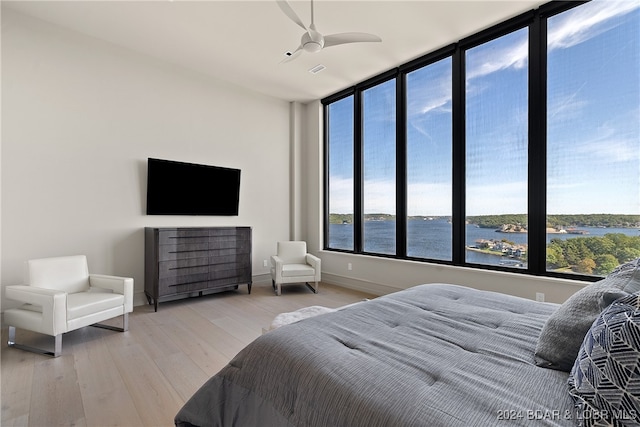 bedroom with ceiling fan and hardwood / wood-style flooring