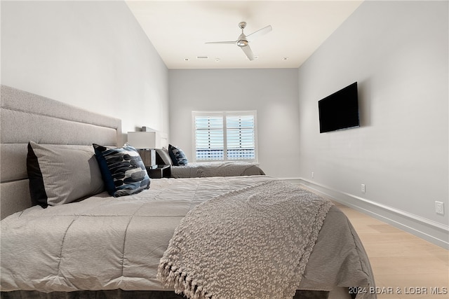 bedroom with ceiling fan and light hardwood / wood-style flooring