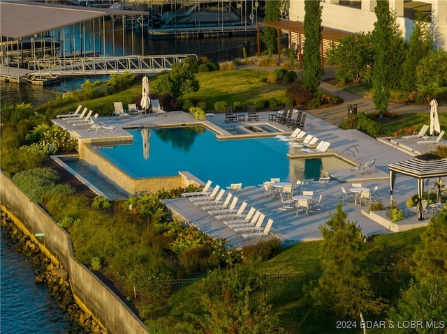 view of swimming pool featuring a patio area and a water view