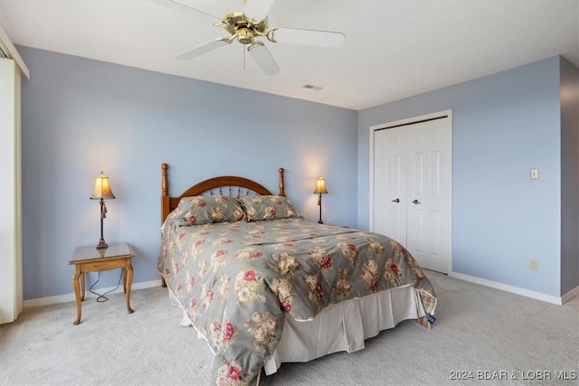 bedroom with ceiling fan, a closet, and light colored carpet