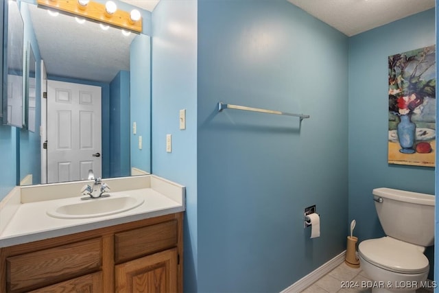 bathroom featuring tile patterned floors, vanity, and toilet