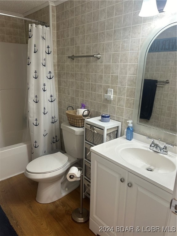 full bathroom featuring toilet, shower / bath combo with shower curtain, vanity, tile walls, and hardwood / wood-style flooring