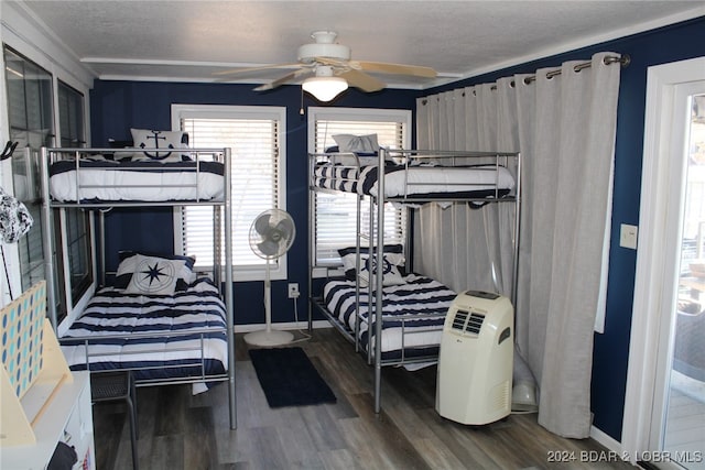 bedroom featuring wood-type flooring, a textured ceiling, and ceiling fan