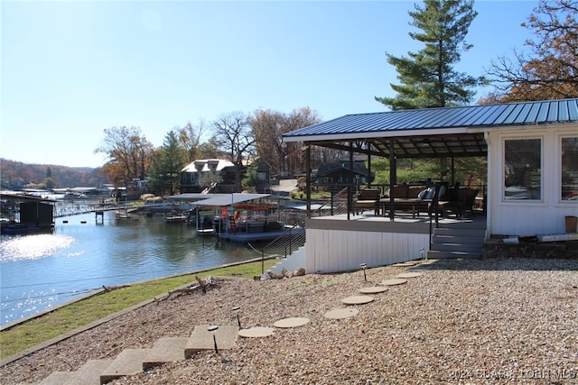 exterior space with a gazebo and a deck with water view