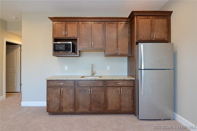 LOT1014 Enclaves Ln, Lake Ozark, MO 65049 - kitchen featuring appliances with stainless steel finishes, a sink, light carpet, and baseboards