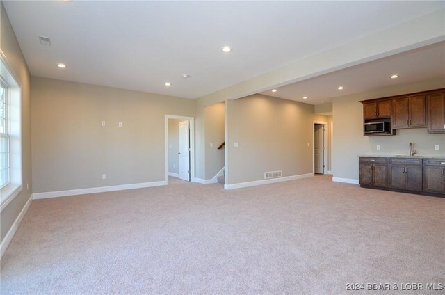 LOT1014 Enclaves Ln, Lake Ozark, MO 65049 - unfurnished living room with light colored carpet, wet bar, recessed lighting, baseboards, and stairs