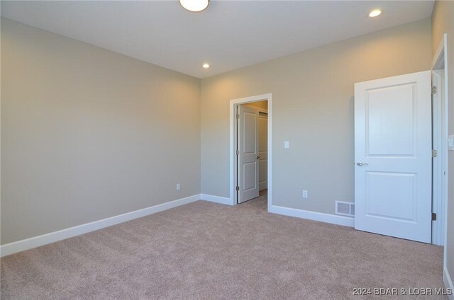 LOT1014 Enclaves Ln, Lake Ozark, MO 65049 - unfurnished bedroom with carpet flooring, baseboards, and recessed lighting