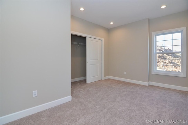 LOT1014 Enclaves Ln, Lake Ozark, MO 65049 - unfurnished bedroom featuring light carpet, recessed lighting, baseboards, and a closet