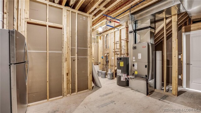 LOT1014 Enclaves Ln, Lake Ozark, MO 65049 - unfinished basement featuring freestanding refrigerator, electric water heater, and heating unit