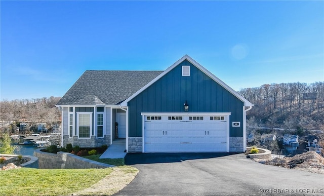 LOT1014 Enclaves Ln, Lake Ozark, MO 65049 - single story home featuring board and batten siding, stone siding, a garage, and asphalt driveway