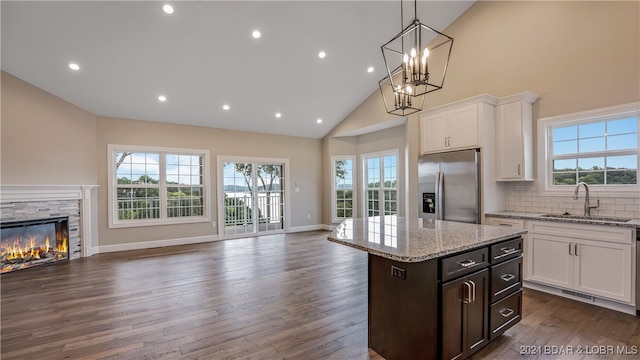 LOT1014 Enclaves Ln, Lake Ozark, MO 65049 - kitchen with stainless steel fridge with ice dispenser, a sink, open floor plan, high vaulted ceiling, and plenty of natural light