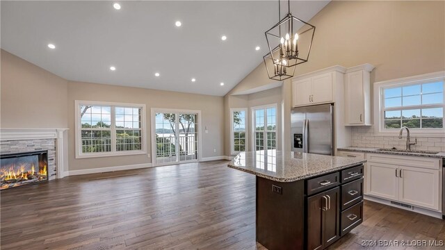 LOT1014 Enclaves Ln, Lake Ozark, MO 65049 - kitchen with stainless steel fridge with ice dispenser, a sink, open floor plan, high vaulted ceiling, and plenty of natural light
