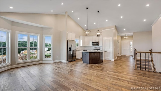 LOT1014 Enclaves Ln, Lake Ozark, MO 65049 - kitchen featuring appliances with stainless steel finishes, a center island, light countertops, white cabinets, and light wood-type flooring
