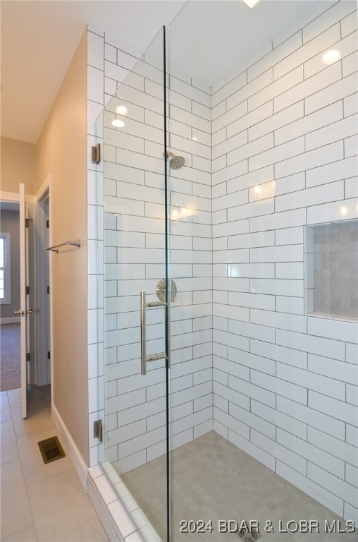 LOT1014 Enclaves Ln, Lake Ozark, MO 65049 - bathroom with a shower stall, tile patterned floors, and baseboards