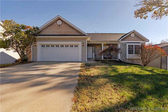 view of front of house with a front yard and a garage