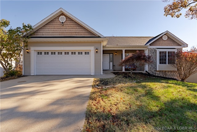 view of front facade with a front yard and a garage