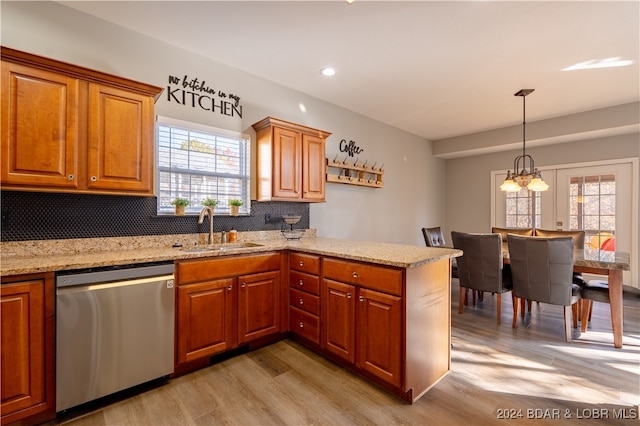 kitchen with a healthy amount of sunlight, sink, stainless steel dishwasher, and light hardwood / wood-style floors