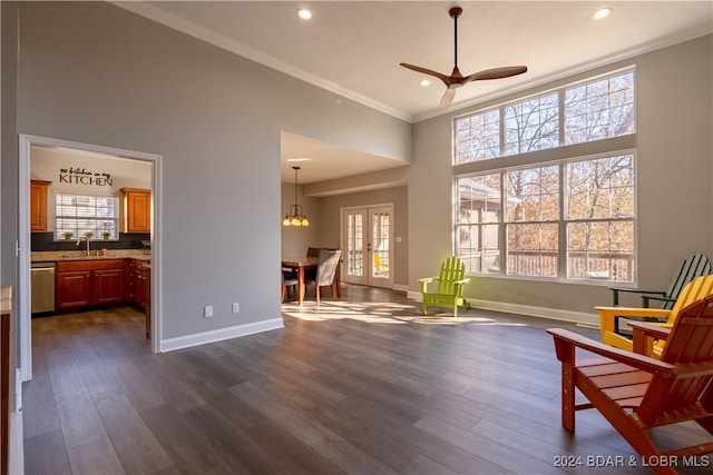 sitting room with dark wood-type flooring and a healthy amount of sunlight