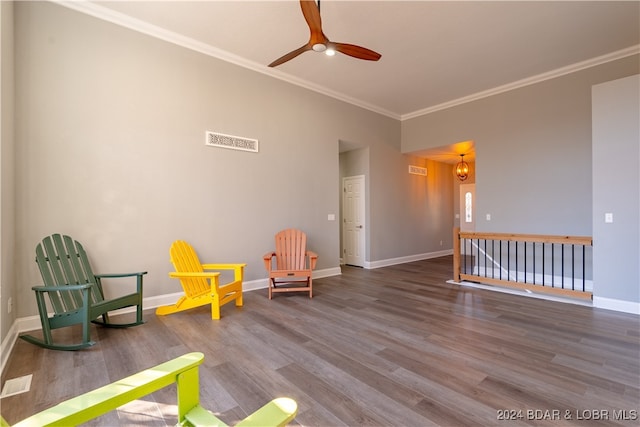 living area with crown molding, ceiling fan, and wood-type flooring