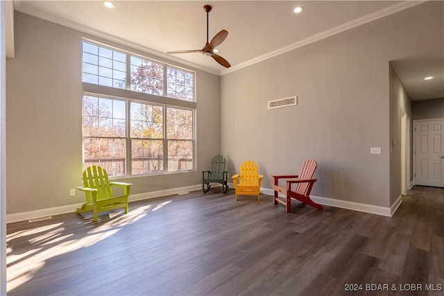 unfurnished room with plenty of natural light, ceiling fan, dark hardwood / wood-style flooring, and ornamental molding