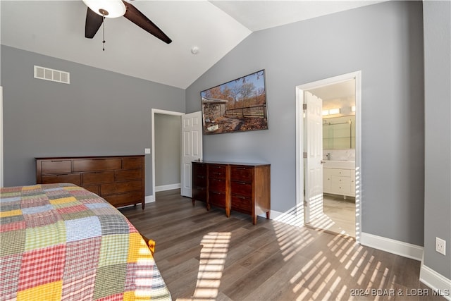 bedroom with ceiling fan, dark hardwood / wood-style flooring, connected bathroom, and vaulted ceiling