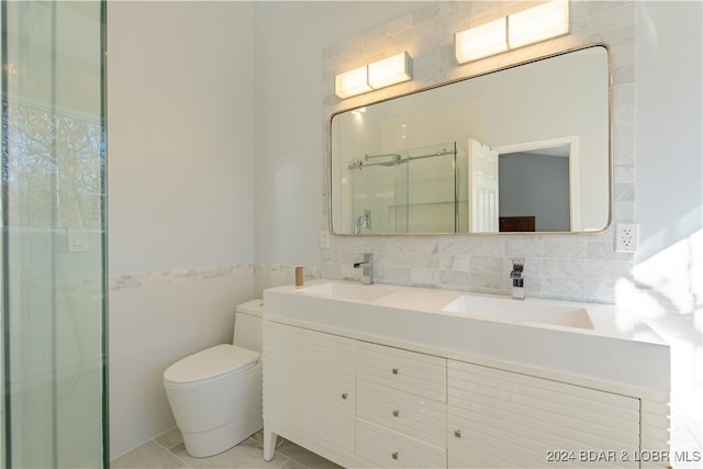 bathroom with tile patterned flooring, an enclosed shower, toilet, decorative backsplash, and vanity