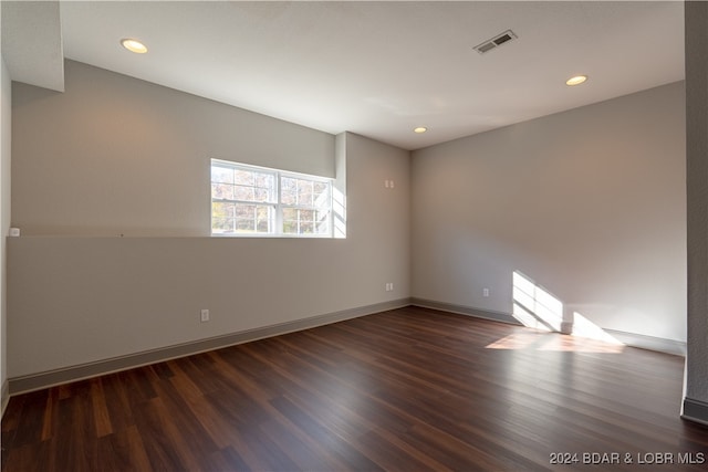 spare room with dark hardwood / wood-style floors