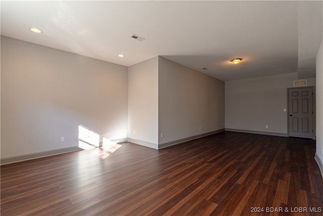 spare room featuring dark hardwood / wood-style floors