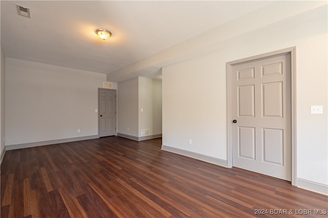 spare room featuring dark wood-type flooring