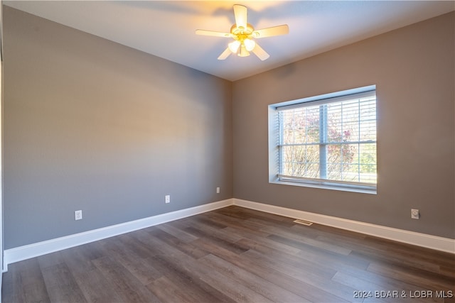 unfurnished room featuring ceiling fan and dark wood-type flooring