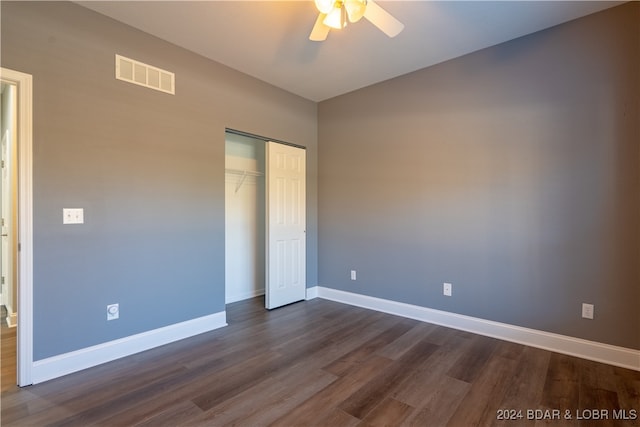 unfurnished bedroom featuring ceiling fan, a closet, and dark hardwood / wood-style floors