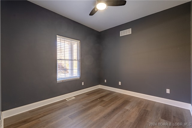 spare room featuring hardwood / wood-style floors and ceiling fan