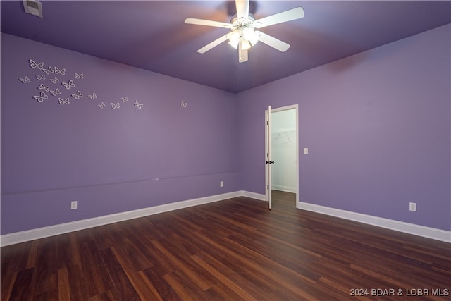 spare room featuring ceiling fan and dark hardwood / wood-style floors