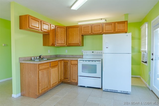 kitchen featuring white appliances and sink