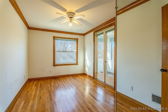 unfurnished room with light wood-type flooring, ceiling fan, and crown molding