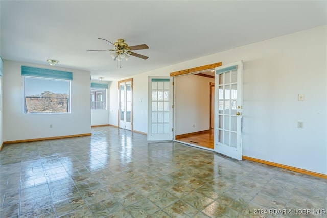 unfurnished room featuring ceiling fan and french doors