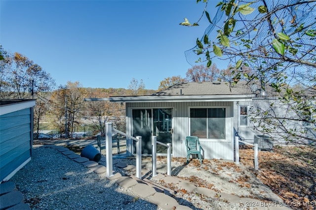 rear view of property featuring central AC unit