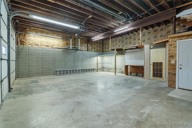 basement featuring brick wall