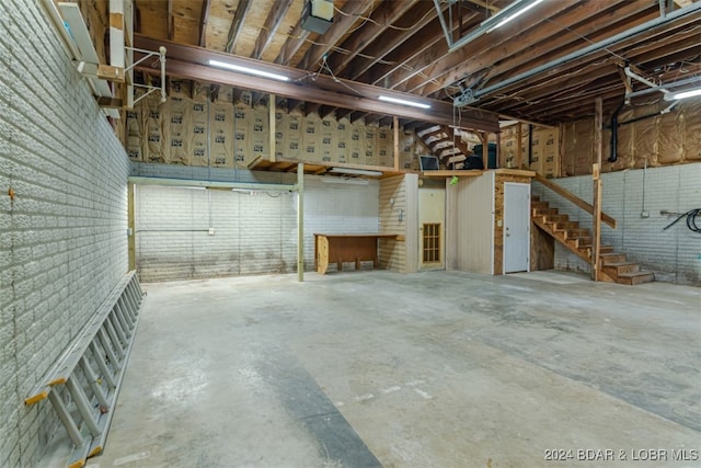 basement featuring brick wall