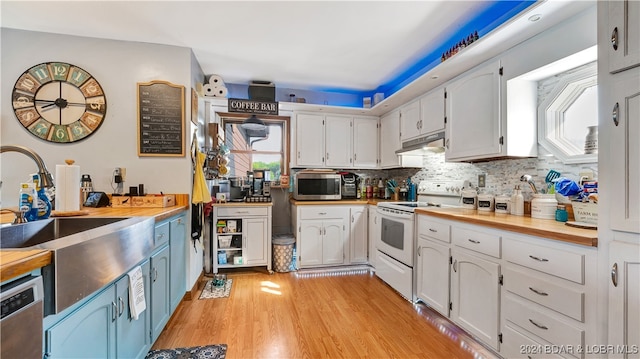 kitchen featuring wooden counters, white cabinets, sink, light wood-type flooring, and stainless steel appliances