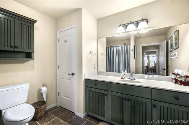 bathroom featuring toilet, vanity, and tile patterned floors