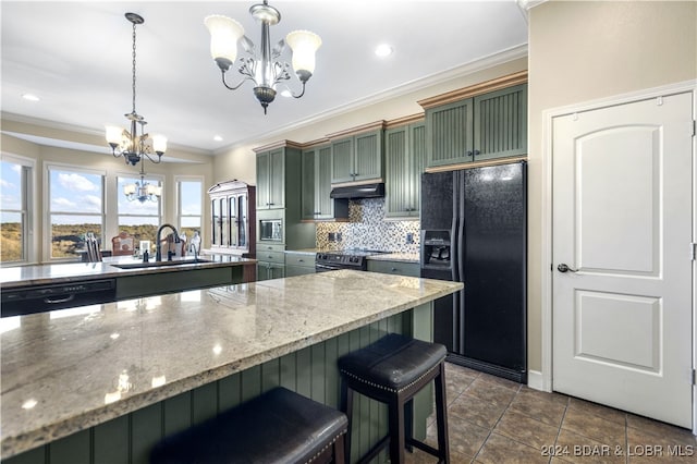 kitchen with sink, hanging light fixtures, a chandelier, black appliances, and green cabinetry