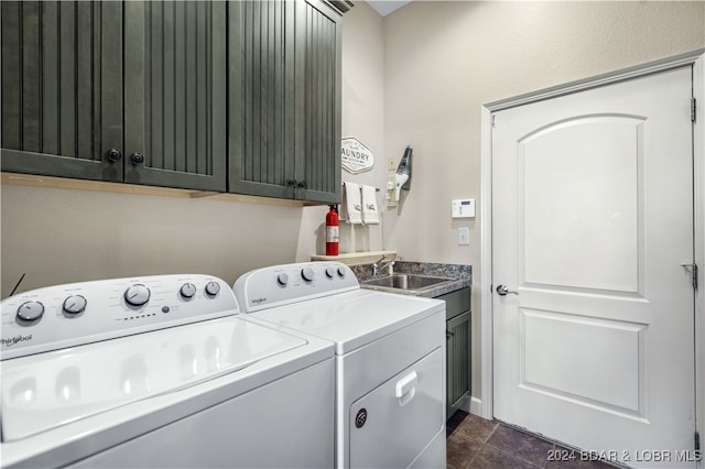 washroom with cabinets, separate washer and dryer, and sink