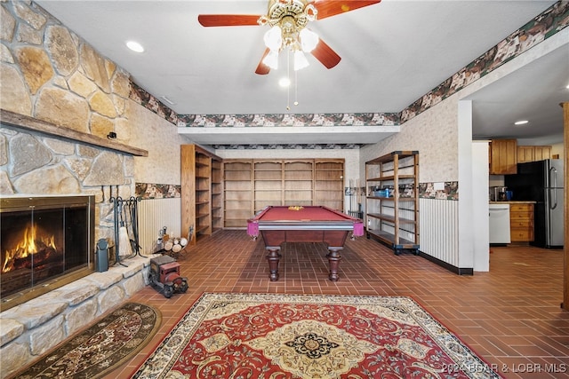 recreation room with ceiling fan, a fireplace, and billiards