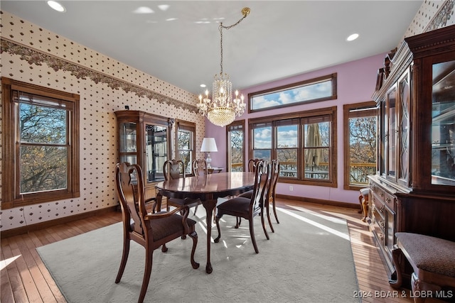 dining area featuring an inviting chandelier and light hardwood / wood-style flooring